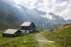 Hike in Swiss Alps with nature views; shepherd's house in mountains; cable car station; chalet