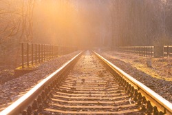 Dream journey. Railroad tracks at sunset time. Summer haze.