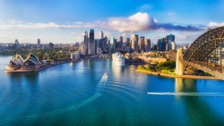 Major architecture landmarks of the city of Sydney and Australia around Sydney harbour in elevated aerial view in warm smooth sunlight at the morning.