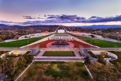 Aerial view around Capitol hill in Canberra - Australian Capital Territory. Facade of public government building with square and surrounding park lands.