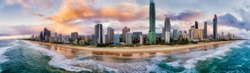 Waterfront of Surfers Paradise Gold Coast city scape urban towers over wide sandy long beach on Australian Pacific coast in Queensland - aerial panoramic view from sea.