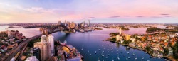 Sydney harbour and major city landmakrs around Lavender bay in aerial panorama at sunrise.