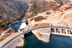 Power generation dam on Snowy River in Snowy mountains of Australia - Lake Jindabyne. Aerial top down view over gate and spillway.