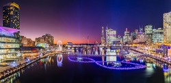 Short bright sunset panorama of Darling harbour Cockle bay in Sydney city CBD at Vivid Sydney light festival show.