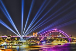 Colourful illumination of Sydney Harbour bridge and overseas passenger terminal around Circular Quay and The Rocks during Vivid Sydney light show and festival.