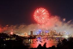 Sydney new year fireworks big red ball of pyrotechnics fire flashes above city, harbour and bridge