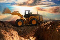 Wheel loader are digging the soil in the construction site on the  sunlight background
