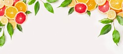 Citrus fruits slice with green leaves on white wooden background, banner for website