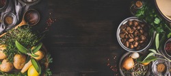 Chestnuts cooking ingredients on dark rustic background, top view, place for text. Seasonal food and eating. Banner