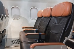 Empty aircraft seats and windows, passenger seat interior airplane, Chair on plane, cabin with modern leather chair, travel and airline business conept
