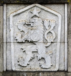 State emblem, symbol of communist Czechoslovakia, a two-tailed lion with a five-pointed star, Hussite shield in the background.