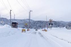 Railroad crossing in the countryside on a snowy day