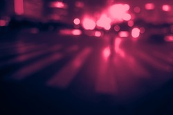 Perfect background image of blurred night street with unrecognizable people. Vintage looking image with washed out colors and red color cast