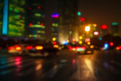 Abstract background of People across the crosswalk at night in Shanghai, China. Perfect background image of blurred night street with unrecognizable people and cars in night illumination