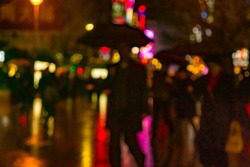 Abstract background of People across the crosswalk at night in Shanghai, China. Perfect background image of blurred night street with unrecognizable people and cars in night illumination