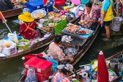 Colorful trader's boats in a floating market in Thailand. Floating markets are one of the main cultural tourist destinations in Asia.