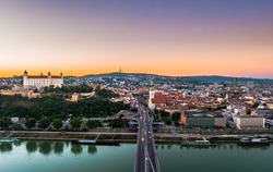 Night view of Bratislava city center with Cathedral, historical buildings, and traffic. Beautiful travel picture of Slovakia.