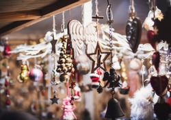 Christmas market stall with handcrafted wooden christmas decorations. Traditional Christmas fair in Europe 