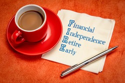 FIRE acronym - financial independence, retire early, handwriting on a napkin with a cup of coffee