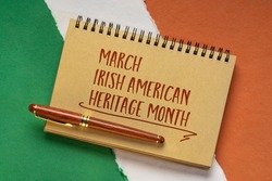 March Irish American Heritage Month - handwriting in a notebook against  paper abstract in colors of national flag of Ireland (green, white and orange), reminder of cultural event