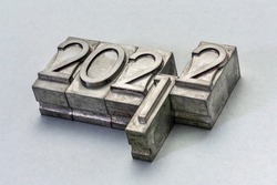 2022 and 2001 years typography - number abstract in grunge letterpress metal type against textured paper, New and Old years concept