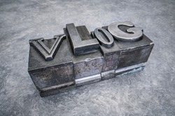 vlog word abstract in gritty vintage letterpress metal types against textured handmade paper, mixed fonts, social media and communication concept