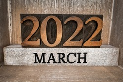 2022 March typography in vintage letterpress wood type inside grunge wooden box, low angle macro shot, calendar concept