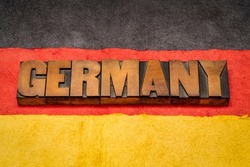 Germany  word abstract in vintage letterpress wood type against paper abstract in black, red and yellow colors of German national flag