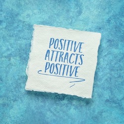 positive attracts positive - law of attraction concept - inspirational note on a handmade paper