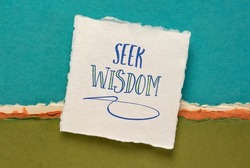 seek wisdom advice or reminder handwriting on a handmade paper against abstract landscape