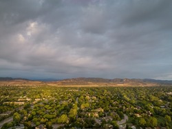 summer morning over Fort Collins and foothills of Rocky Mountains in northern Colorado, aerial view with heavy clouds