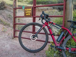 gravel bike at a cattle gate on a trail in Colorado foothills, Soapstone Prairie Natural Area