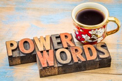 power words - text in vintage letterpress wood type printing blocks against painted wood with a cup of coffee