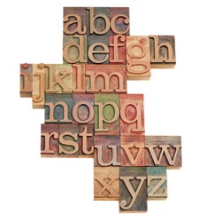 alphabet - abstract of vintage wooden letterpress printing blocks stained by color inks, isolated on white