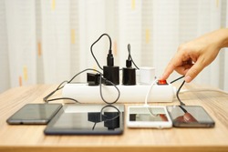 man is turning off  power adapters for mobile phones and tablet computers