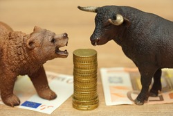 bull and bear and money. investing,risk,stock market,finance,money concept