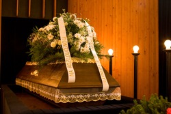 Wooden caseket at a funeral - funereal ceremony