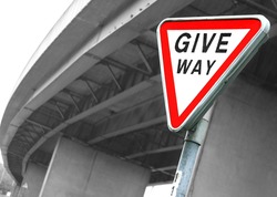 Road sign Give Way. British road sign Give Way opposite the motorway bridge by rainy day