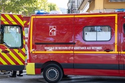 French fire truck, with written on it in French rescue and assistance vehicle for victims, in intervention in a street