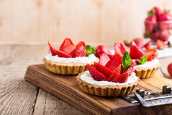 Strawberry shortcake pies on rustic wooden table,  perfect party individual fresh fruit dessert 