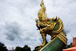 Ancient art of naga or antique naka statue of Wat Phra Kaew temple for thai people travelers travel visit and respect praying and blessing holy mystery worship at Chainat city in Chai Nat, Thailand