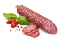 Dry sausage or salami with basil and spices, close-up, isolated on white background.