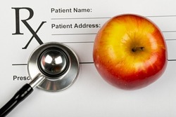 Picture of patient's fill in form a stethoscope and an apple  
