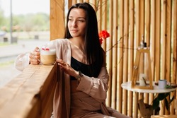 Pretty woman drinking latte in coffee shop