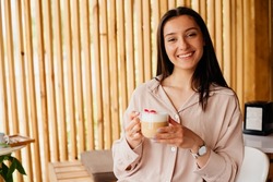 Pretty woman drinking latte in a coffee shop