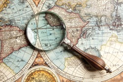 Magnifying glass and ancient old map