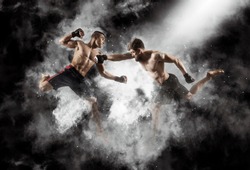 MMA boxers fighters fight in fights without rules.  Smoke background
