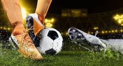 Two football player man in action on dark arena background. Soccer player making sliding tackle