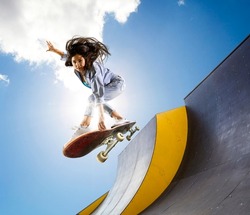 Skateboarder doing a jumping trick. Freestyle extreme sports concept