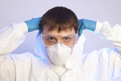 Virologist. Male professional in hooded suit for bio-hazard protection 